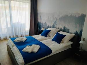 ein Schlafzimmer mit einem Bett mit zwei Handtüchern darauf in der Unterkunft Apartament Złota Brama in Lyck