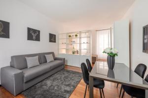 a living room with a couch and a table at Milan Royal Suites - Centro in Milan