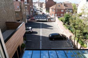 a car parked in a parking lot on a city street at Hôtel Merveilleux Côté Mer in Dunkerque