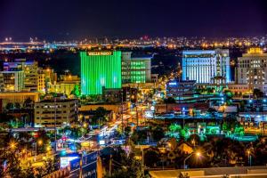 a city lit up at night with lights at Super 8 by Wyndham Albuquerque West/Coors Blvd in Albuquerque