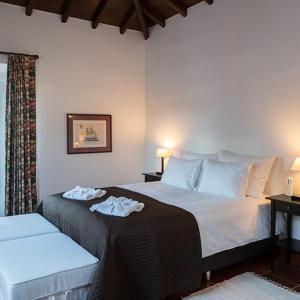 a bedroom with a bed with two towels on it at Hotel Rural Monte da Provença in Elvas