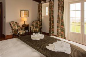 a hotel room with a bed with towels on it at Hotel Rural Monte da Provença in Elvas