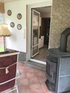 - un salon avec une cuisinière et une porte dans l'établissement Ferienwohnung Gürth, à Kleinhennersdorf