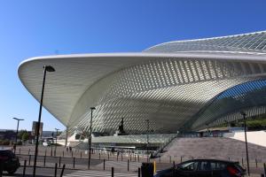 een groot wit gebouw met een auto ervoor geparkeerd bij ibis Styles Liege Guillemins in Luik