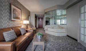 a living room with a couch and a tub at Monte Carlo Inn Markham in Markham