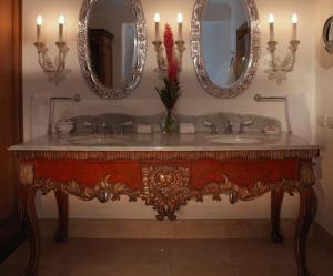 La salle de bains est pourvue de 2 lavabos et de 2 miroirs. dans l'établissement Palacio Nazarenas, A Belmond Hotel, Cusco, à Cusco