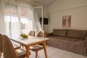 a living room with a table and a couch at Nicole Fresh Apartments in Keramotí