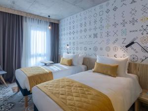 เตียงในห้องที่ ibis Styles Bucharest City Center