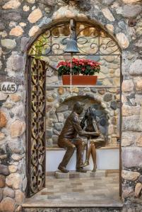 a statue of a couple sitting on a ledge at Casa Kimberly Boutique Hotel in Puerto Vallarta