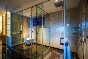 a bathroom with a glass shower with a sink at Crowne Plaza Greater Noida, an IHG Hotel in Greater Noida