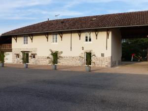 un grande edificio bianco con tetto marrone di Gites Domaine de la Rochere a Domsure