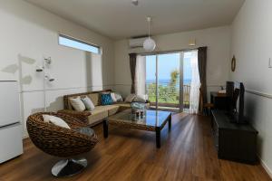 a living room with a couch and a table at Odysis Onna Resort Hotel in Onna