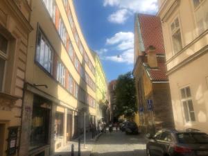 a street in a city with buildings and a car at Ragtime in Prague