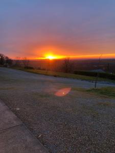 een lege weg met de zonsondergang op de achtergrond bij The Collins,Our View from The Top in Listowel