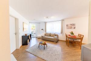 sala de estar con sofá y mesa en Braviscasa - Ferienresidenz Haus am Bach Vogtsburg am Kaiserstuhl, en Vogtsburg