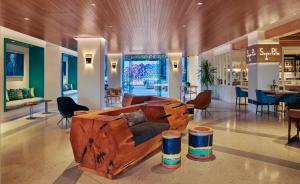 a living room with a wooden couch in the middle at Viceroy Santa Monica in Los Angeles