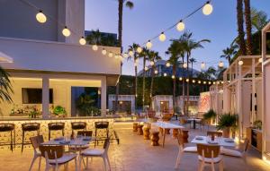 a patio with tables and chairs and lights at Viceroy Santa Monica in Los Angeles