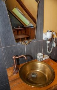 a sink in a bathroom with a mirror at Baltā māja in Pilsrundāle