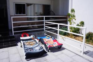 a baby carriage and aroller sitting on a porch at Casinha das Bonecas - Casa com Piscina Privada in Aveiro