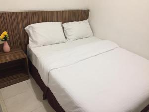 Postel nebo postele na pokoji v ubytování Fragrance Hotel Johor Bahru