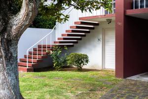 una rampa di scale accanto a una casa con un albero di Snooker House a Ponta Delgada