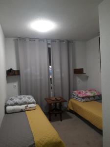 Kleines Zimmer mit 2 Betten und einem Tisch in der Unterkunft Stacja Wypoczynkowa Augustów in Augustów