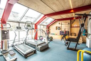 a gym with treadmills and machines in a room at Sertorelli Sporthotel in Breuil-Cervinia