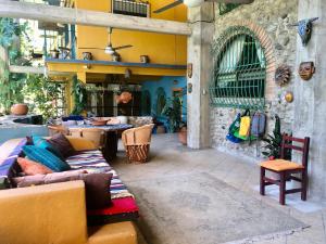 an outdoor patio with couches and a table and chairs at Casa Cereza Apartments in Puerto Vallarta