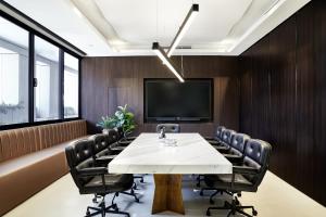 a conference room with a table and chairs and a tv at Crowne Plaza Sydney Burwood by IHG in Sydney