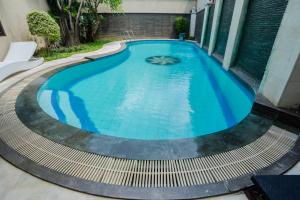 The swimming pool at or close to ARCS House Menteng by Jambuluwuk