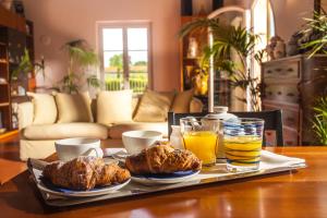 a tray with muffins and orange juice on a table at Cascina Canova B&B in San Giuliano Terme