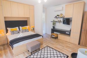 a bedroom with a large bed and a desk at Sevastopol apartments Varna in Varna City