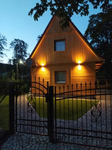 a house with a fence in front of it at Sosnowa Chata - dom z prywatną sauną in Szklarska Poręba