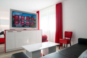 uma sala de estar com um sofá e uma televisão em Hotel Andante Rust em Rust