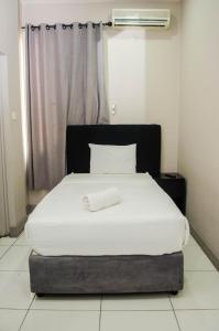 A bed or beds in a room at Residencial Horizonte 2