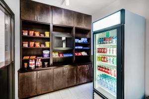 a kitchen with a refrigerator filled with lots of food at Holiday Inn Express & Suites Tell City, an IHG Hotel in Tell City