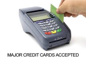 a hand holding a calculator with a green card at Kairali Tourist Home in Guruvāyūr