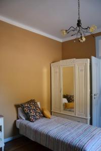 a bedroom with a bed and a dresser with a mirror at Casa da Nonô in Coimbra