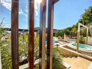 einen Blick vom Balkon eines Hauses mit Pool in der Unterkunft Apartments Secret Garden in Ulcinj