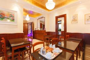 a restaurant with tables and chairs in a room at Hotel Bellevue Saint-Lazare in Paris