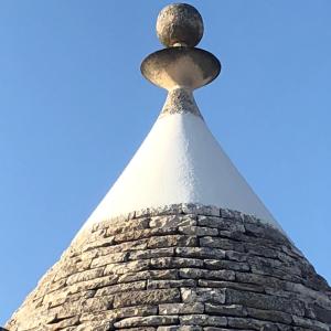 una torre de piedra con una veleta encima en Porto Antico, en Bari