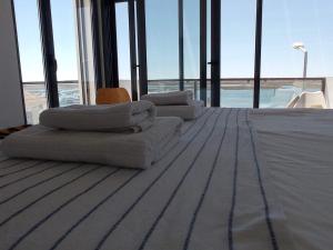 um quarto com duas cadeiras e uma cama com janelas em Flamingo Beach House em Santa Luzia