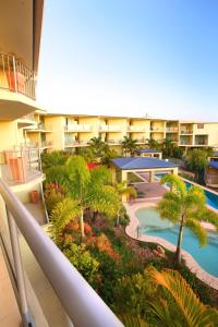 an overhead view of a resort with a pool and palm trees at Caloundra Central Apartment Hotel Official in Caloundra