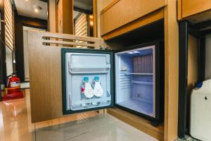 a refrigerator with drinks inside of it in a room at ON City Hotel in Cheonan