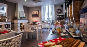 a restaurant with a table with food on it at Hôtel des Alpes in Annecy