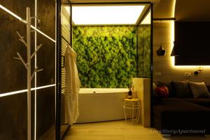 y baño con pared verde y bañera. en Luxury apartments «Love Story», en Ivano-Frankivsk