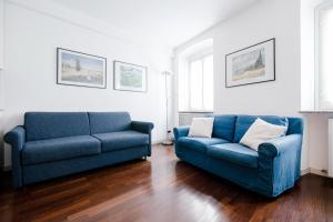 a living room with two blue couches at Downtown Como-Porta Torre Flat in Como