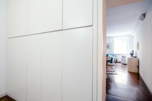 a large white closet in a living room at Downtown Como-Porta Torre Flat in Como