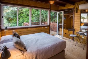 ein Schlafzimmer mit einem Bett und einem großen Fenster in der Unterkunft Casa Castor, Fábrica, Cacela Velha. in Vila Nova De Cacela