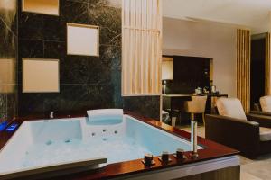 a large bathroom with a tub in a room at Weranda Apartments in Morzyczyn